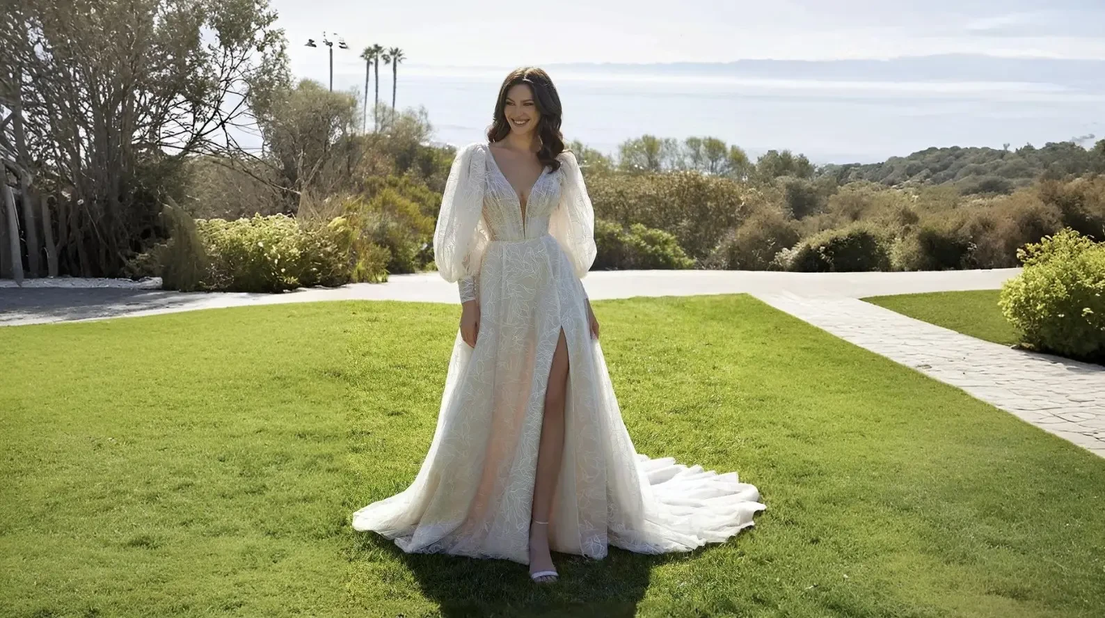 Bride and groom walking hand in hand in a garden.