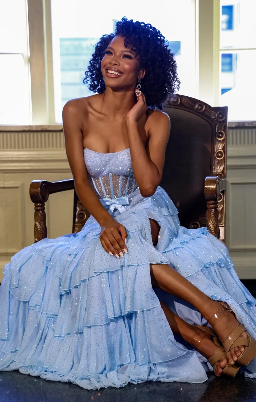 Model wearing gliterry blue prom dress