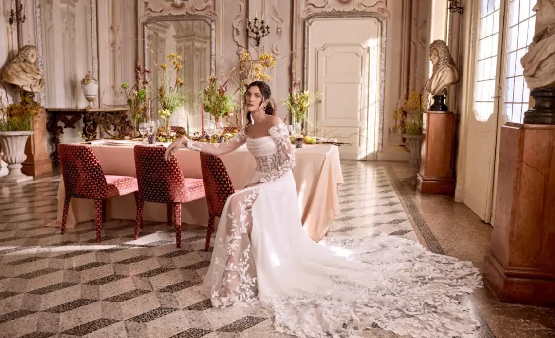 Bride and groom walking hand in hand in a garden.